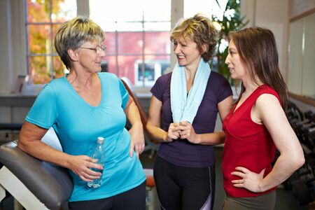 Happy elderly women talking in a gymの写真素材