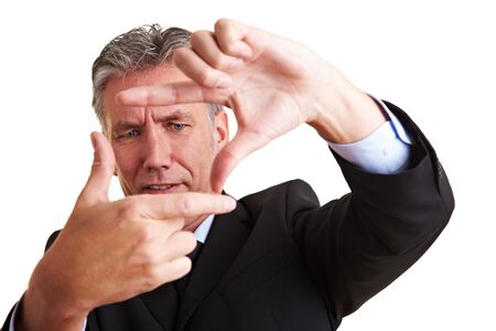 Senior manager making a frame with his fingersの写真素材