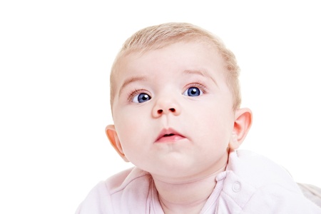 Cute baby girl with big eyes looking upの写真素材