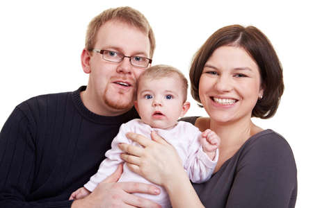 Happy parent smiling with baby girl in their arms