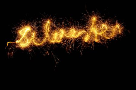 Sparkler at night light writing the word "Silvester"の写真素材
