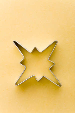 Star shaped cookie cutter on a raw cookie doughの写真素材