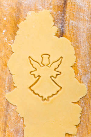 Christmas angel shape in raw cookie doughの写真素材