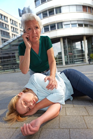 Senior woman making emergency call for ambulance