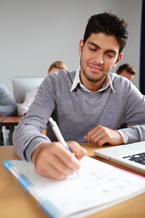 Student taking some notes in university classの写真素材