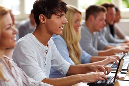 Student using a netbook in university classの写真素材