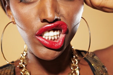 Frustrated young african woman bares her teethの写真素材