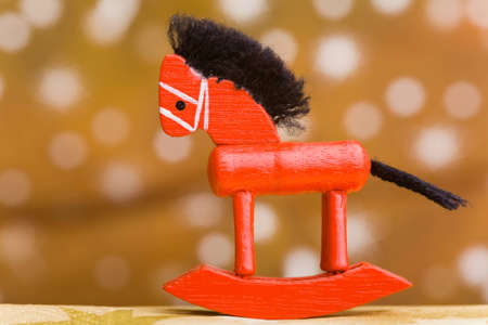 Small wooden rocking horse with christmas star backgroundの写真素材