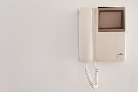 Intercom system with door signal hanging on white wall