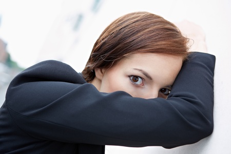 Shy business woman hiding behind her armの写真素材
