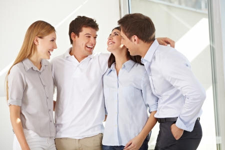 Happy attractive business group standing in an officeの写真素材
