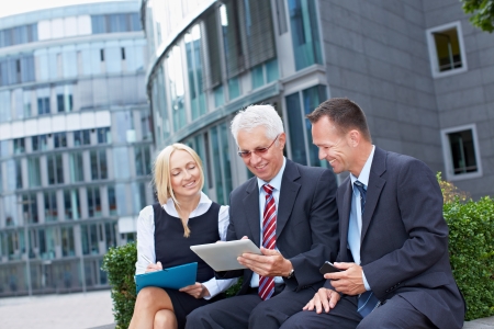 Modern business team working outside the office with tablet PCの写真素材