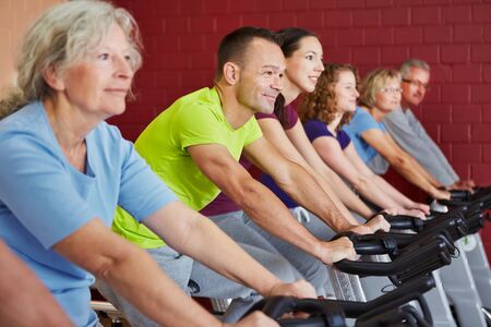 Spinning class exercising in a fitness centerの写真素材