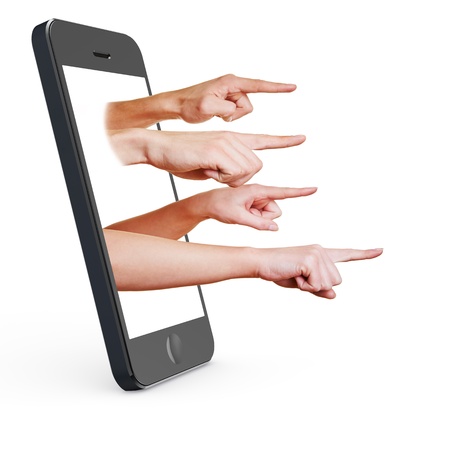 Many fingers pointing out of the display from a smartphoneの写真素材