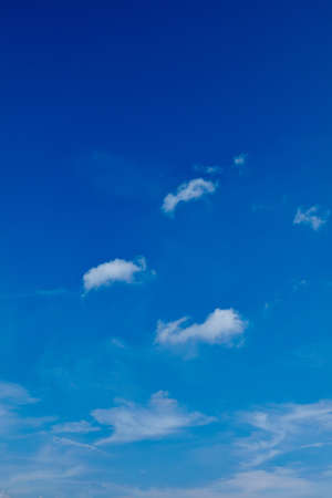 Blue sky with little white clouds in itの写真素材