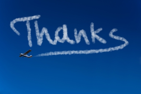 Skywriter writing the word Thanks in the blue skyの写真素材
