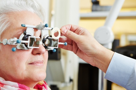 Senior woman with astigmatism and trial frame at the opticianの写真素材