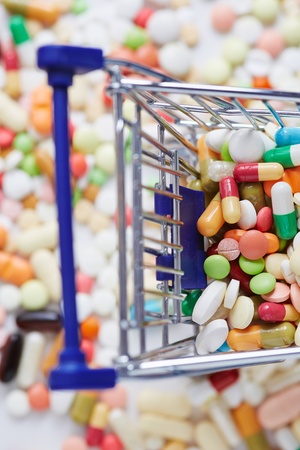 Small shopping cart with different pills and medicationの写真素材