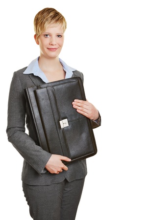Young business woman holding a briefcase in her handsの写真素材