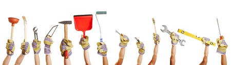 Many hands holding different tools for working and fixing thingsの写真素材