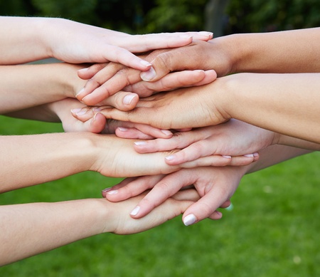 Group of many hands as team motivation concept in nature