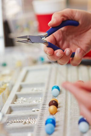 Juweler bending wire for a necklace in a juwelry workshopの写真素材