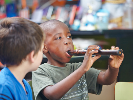 African child playing flute in a music schoolの写真素材