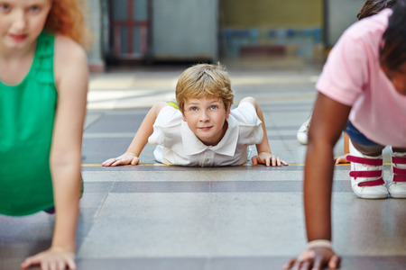 Children doing push ups in PE in elementary school