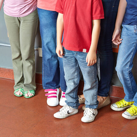 Many children standing together in a group in elementary school