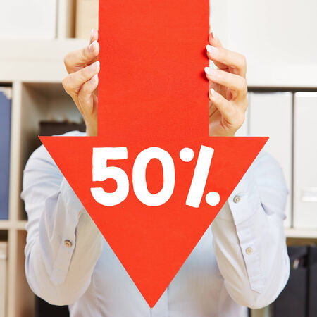 Red arrow with 50% discount being held by female hands