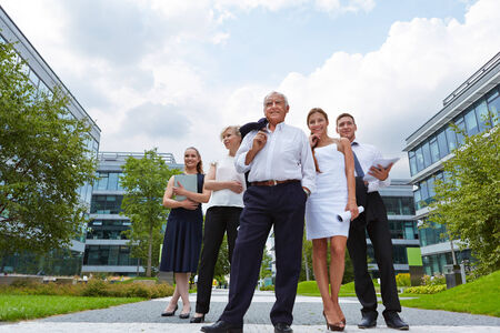 Success through competence in the team with a senior businessmanの写真素材