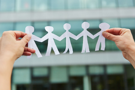 Family with people made of paper held in handsの写真素材