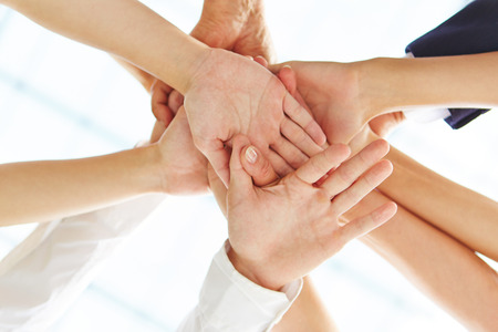 Many hands stacked as concept for motivation and teamwork