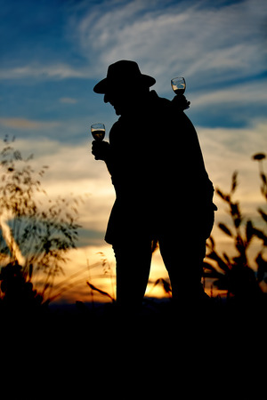 Happy couple with champagne embracing outside with sunsetの写真素材