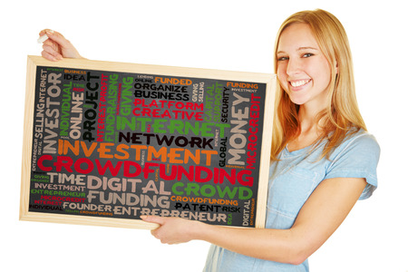 Young woman holding blackboard with crowdfunding concept as a tag cloudの写真素材