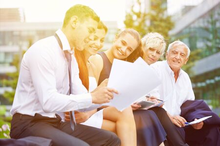 Group of business people planning and talking in summer outdoorsの写真素材