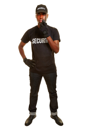 Black man as security guard talking into radio setの写真素材