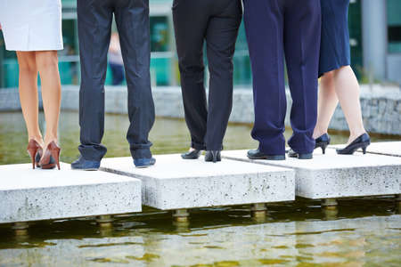 Legs and pants of many business people from behindの写真素材