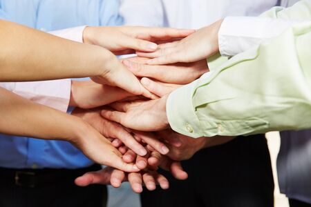 Many hands stacked for motivation in a group of business people