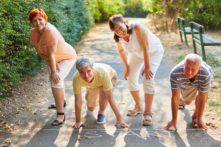 Group of seniors at the sart point of a race in summer at the parkの写真素材