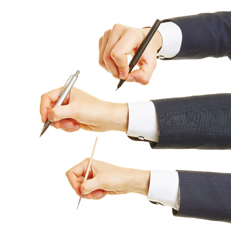 Many hands with writing utensils like pen oder brushの写真素材
