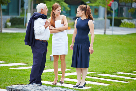 Group of business people talking in front of the officeの写真素材