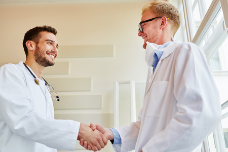 Doctors sharing handshake at hospital