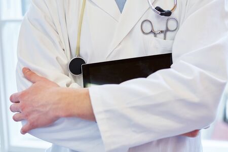 Doctor with tablet and medical instrumentsの写真素材