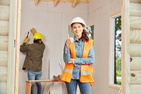 Young woman as apprentice of artisan holding thumbs up 
