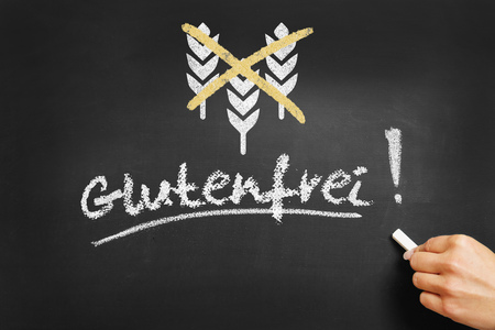 Hand writing in German "Glutenfrei" (gluten free) on a chalkboardの写真素材
