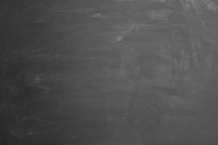 Empty blackboard with slight rests of chalk as backgroundの写真素材
