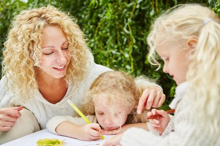 Kids painting in kidergarten and drwaing while learningの写真素材