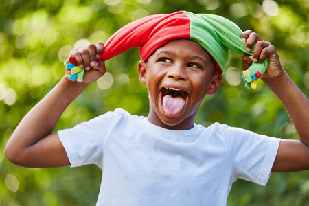Child as court fool having fun showing his tongueの写真素材