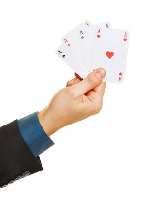 Hand holding four different aces while playing poker